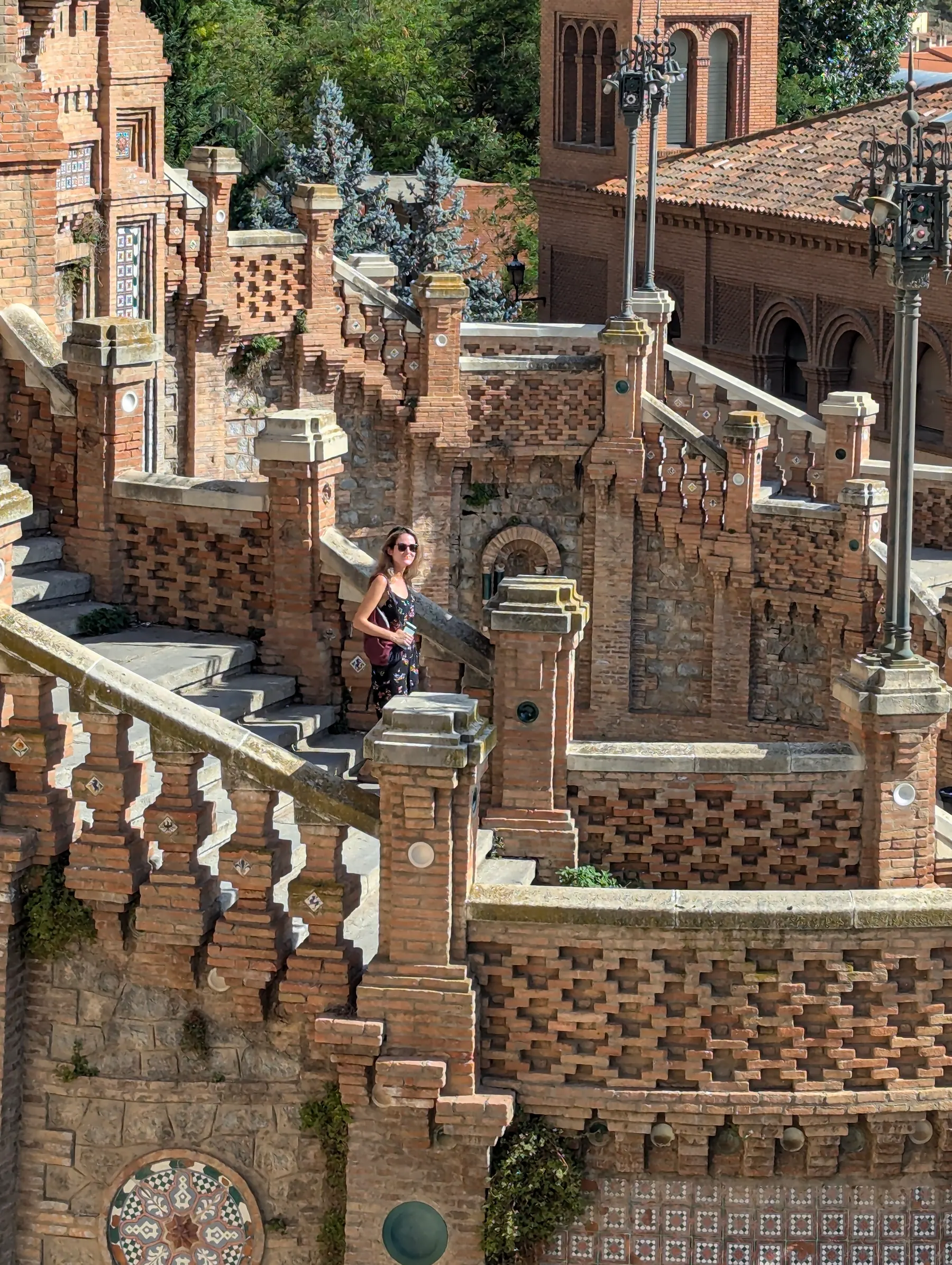 A traveler on the Neo-Mudéjar Escalinata del Óvalo in Teruel
