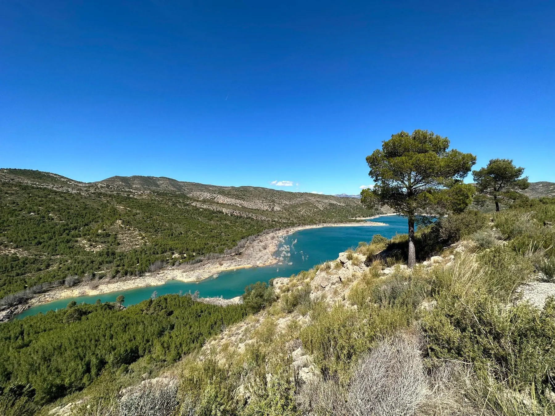 Elevated view of limestone canyon cliffs and the calm waters of the Loriguilla reservoir