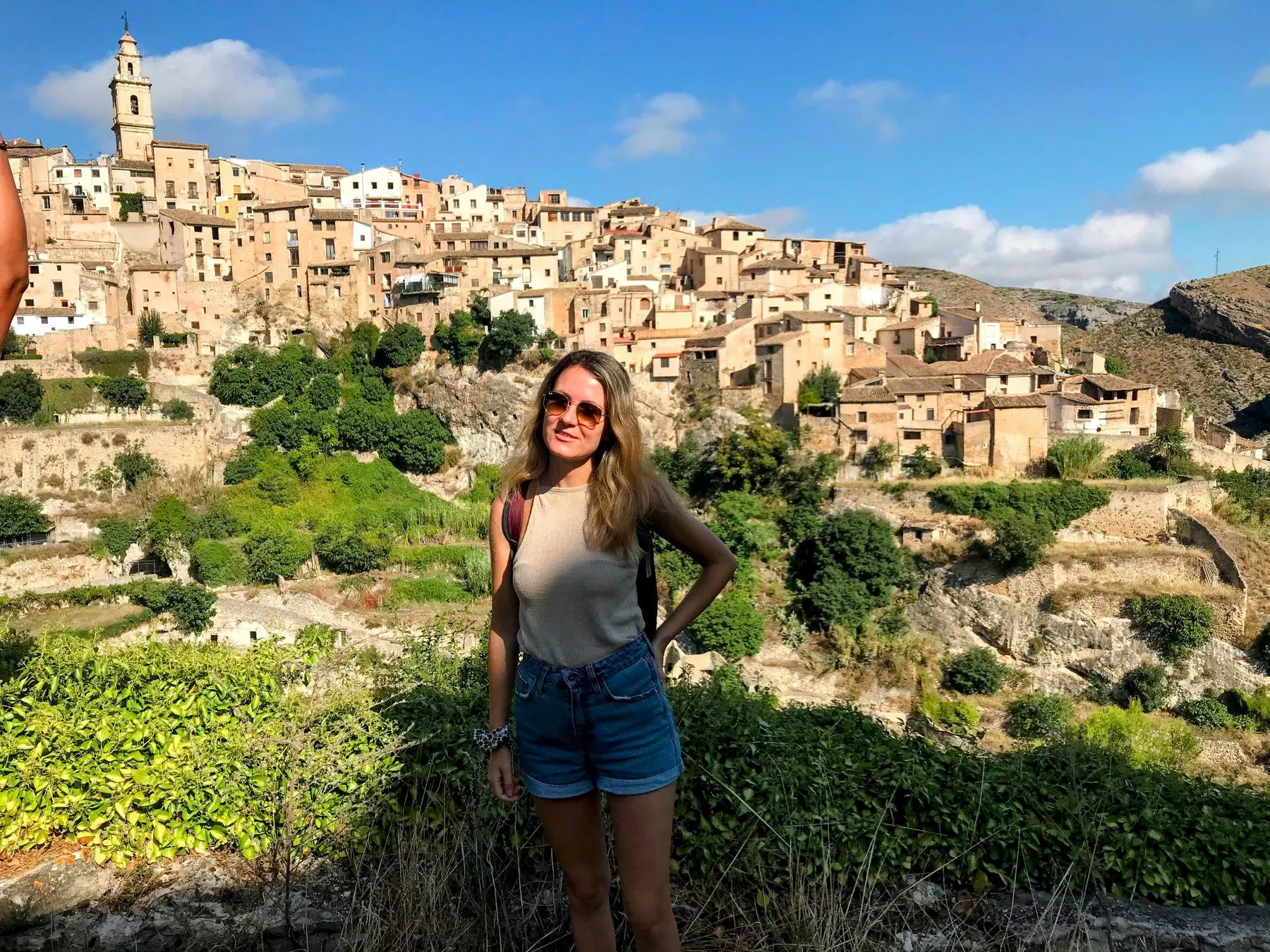 Zane looking across the deep gorge towards the medieval stone town of Bocairent clustered on the hill