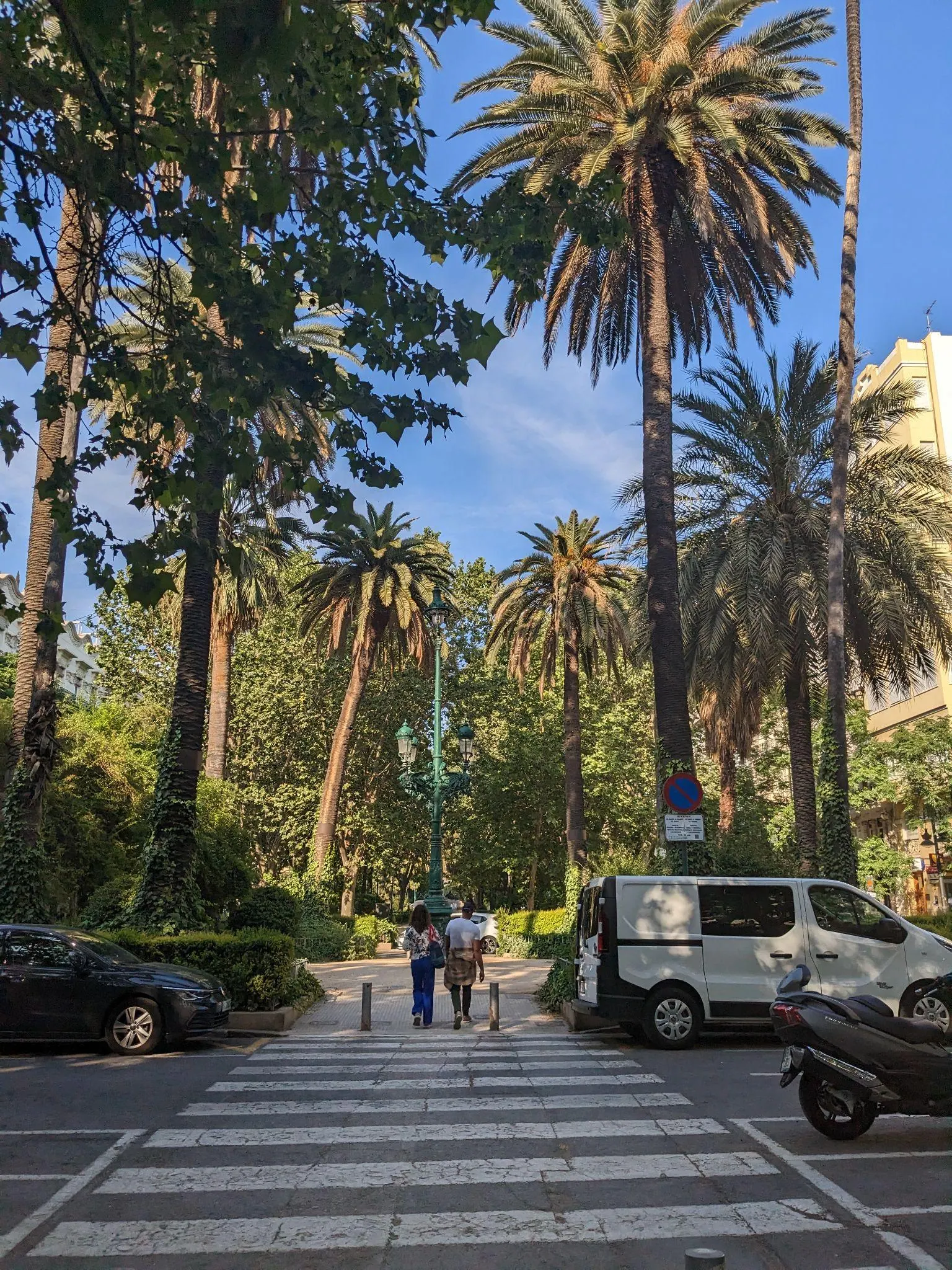 Bulevar arbolado con palmeras y paso de peatones en la Gran Vía Marqués del Turia hacia Ruzafa