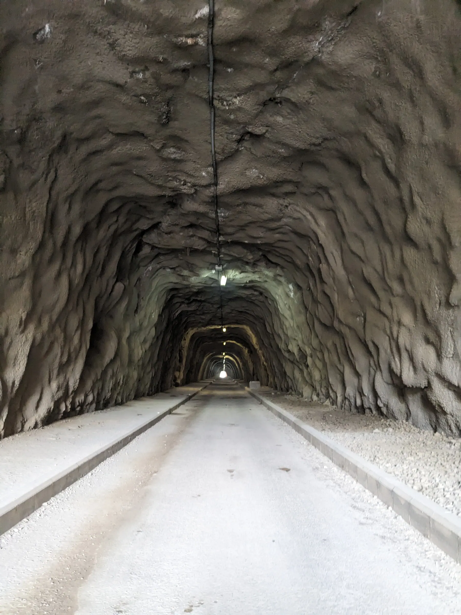 The long illuminated railway tunnel on the Via Verde del Mar